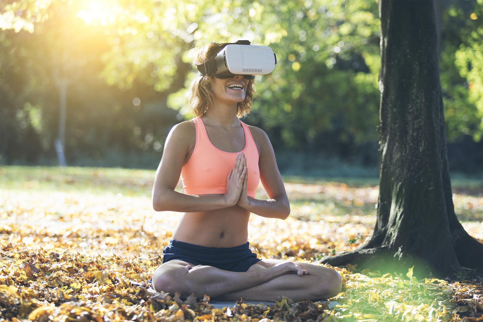Frau beim Yoga mit VR-Brille